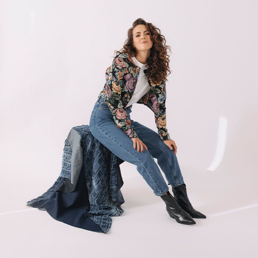 Kačka má na sebe mom džínsy v typickom rifľovom odtieni, biele tričko a kratšie kvetované sako. Celý outfit je od českej značky Buga, ktorá šije s dôrazom na kvalitu a udržateľnosť.